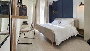a bedroom with a bed and a chair in it at MASA 2Rooms in Piazza Armerina