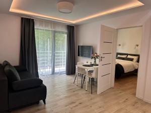 a bedroom with a bed and a table and a mirror at Villa Kryspinów K&J in Kryspinów