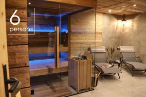 a room with two chairs and a glass wall at Chalet Gipfelsturm in Haus im Ennstal