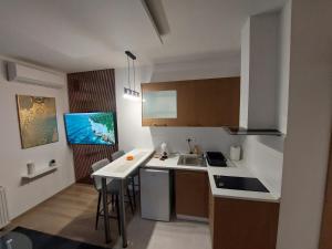 a small kitchen with a sink and a counter at Oaza Apartmani Jakovo HERA in Jakovo +6 photos