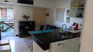 a kitchen with a black counter top and a sink at Eco Paradise ART Apt.203 in Cumbuco