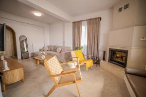 a living room with a couch and a fireplace at Golden Horizon seafront in Goúdhouros