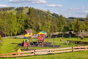 a playground in a field with people playing in it at Resort Abertham - penzion Ellen in Abertamy