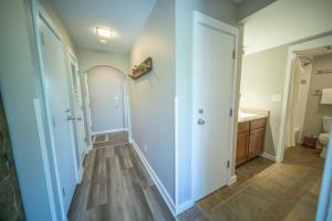 a bathroom with a hallway with a toilet and a sink at Argentine 1511 by SummitCove Lodging in Colorado in Keystone