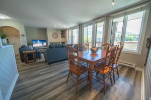 a dining room and living room with a table and chairs at Argentine 1511 by SummitCove Lodging in Colorado in Keystone