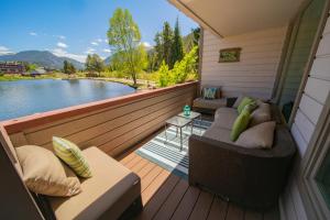 a balcony with couches and a view of a lake at Argentine 1511 by SummitCove Lodging in Colorado in Keystone