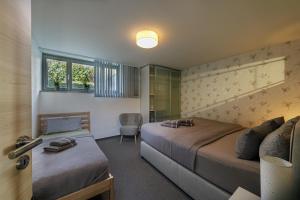 a bedroom with two beds and a chair in it at Monopol Apartments in Wernigerode