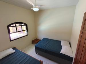 a bedroom with a bed and a window in it at Oásis - Casa com Piscina e Churrasqueira in Pontal do Paraná +35 photos