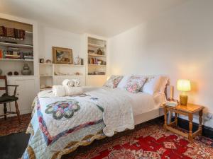a bedroom with a bed and a table with a lamp at Blackbird Cottage near Appledore in Bideford