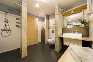 a bathroom with a sink and a toilet at Monopol Apartments in Wernigerode +72 photos