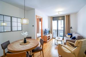 a living room with a table and a couch at Allotjament el Pont in Camprodon +36 photos