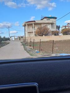 a building on the side of a road at فيلا الاحلام السعيدة in Ar Ramthā