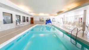 a large swimming pool with blue water in a building at Holiday Inn Express Hotel & Suites Anderson by IHG in Anderson