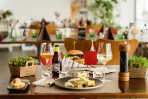a table with a sandwich and a plate of food at Hotel Haus Sonnblick in Bad Kleinkirchheim