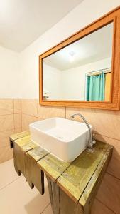 a bathroom with a white sink and a mirror at Pacific Blue in Monterrico +19 photos