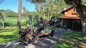 a group of people riding in a toy truck at Pousada Caminho do Lago in Rio Rufino