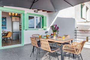 a dining room with a table and chairs at Larimis House in Loutraki