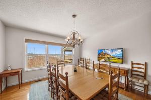 a dining room with a wooden table and chairs at Oma's Beech House in Beech Mountain