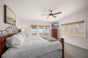 a bedroom with a bed and a ceiling fan at Oma's Beech House in Beech Mountain +33 photos