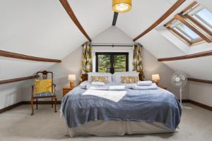 a bedroom with a large bed in a attic at 4 Bed in Newport oc-88913 in Porchfield