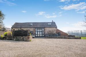 an old stone house with a gravel driveway at 4 Bed in Newport oc-88913 in Porchfield