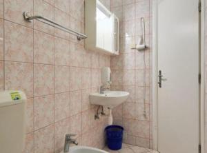 a bathroom with a sink and a toilet and a mirror at Villa Azure Saplunara in Saplunara +98 photos