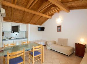a kitchen and living room with a table and a couch at Villa Azure Saplunara in Saplunara