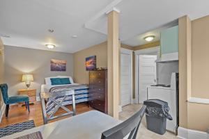 a small bedroom with a bed and a kitchen at Chic Midstream Studio WiFi Parking in St. John's