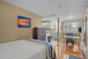 a bedroom with a bed and a kitchen at Chic Midstream Studio WiFi Parking in St. John's
