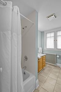 a bathroom with a shower and a bath tub at Chic Midstream Studio WiFi Parking in St. John's