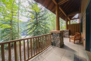 a screened in porch of a cabin with a stone fireplace at Arapahoe Lodge 8105 by SummitCove Lodging in Colorado in Keystone