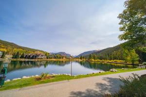 a lake in the middle of a town with mountains at Argentine 1504 by SummitCove Lodging in Colorado in Keystone