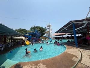 a group of people in a pool at a water park at Casa Bugambilia in Paso Hondo