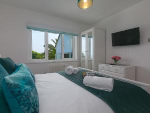 a bedroom with a bed with towels on it at Millies in St Ives