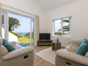 a living room with two couches and a television at Millies in St Ives