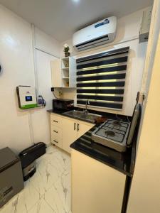 a kitchen with a sink and a printer on a counter at Studio apartment-Akilo in Lagos