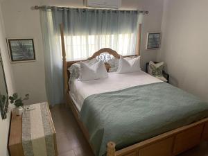 a bedroom with a large bed with a window at Tropical Landhouse in Sánchez +67 photos