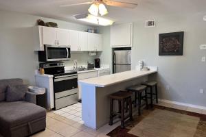 a kitchen with white cabinets and a counter top at Tropical Isle #112 in Fort Walton Beach