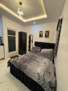 a bedroom with a large bed in a room at Studio apartment-Akilo in Lagos