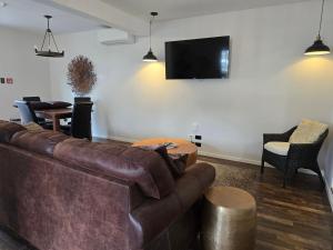 a living room with a couch and a flat screen tv at City Living in New Plymouth