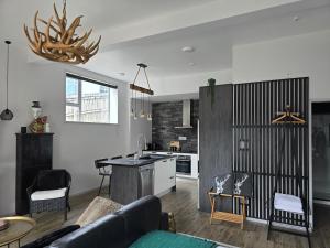a kitchen and living room with a couch and a table at City Living in New Plymouth