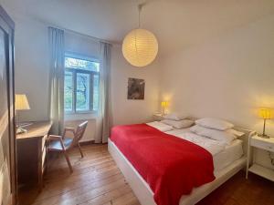 a bedroom with a large bed with a red blanket at Wienerwaldhof in Irenental +48 photos