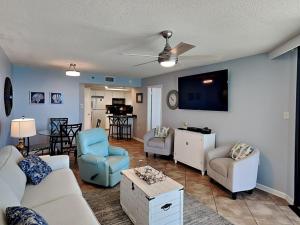 a living room with a couch and chairs and a tv at Phoenix III #3146 in Orange Beach