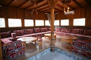 a large room with couches and tables and windows at Hotel Aventus -Novi Pazar Banja in Novi Pazar +190 photos