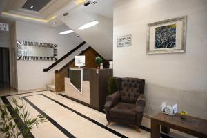 a waiting room with a chair and a staircase at Hotel Aventus -Novi Pazar Banja in Novi Pazar