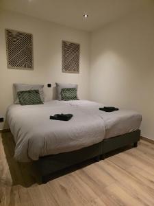a bedroom with a large bed with two towels on it at Alpa Farm Rouveen in Rouveen