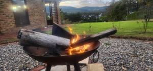 a grill with a fire in a yard at Finca El Recuerdo in Guatavita