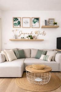 a living room with a couch and a coffee table at Japandi Suites Olbia in Olbia