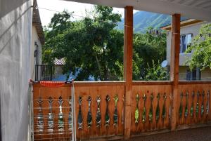 a wooden fence with a view of a house at Budget Hostel in Mestia in Mestia +5 photos