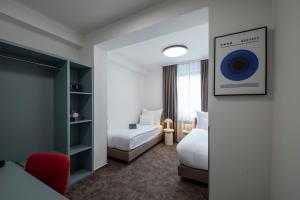 a hotel room with two beds and a window at Boutique Hotel Prokopovka 34 in Pilsen